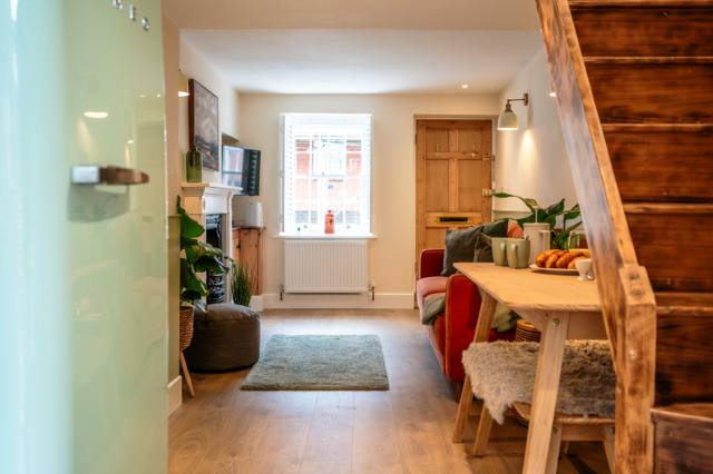 Interior of the Somerset holiday cottage looking past the breakfast table and staircase to the front door