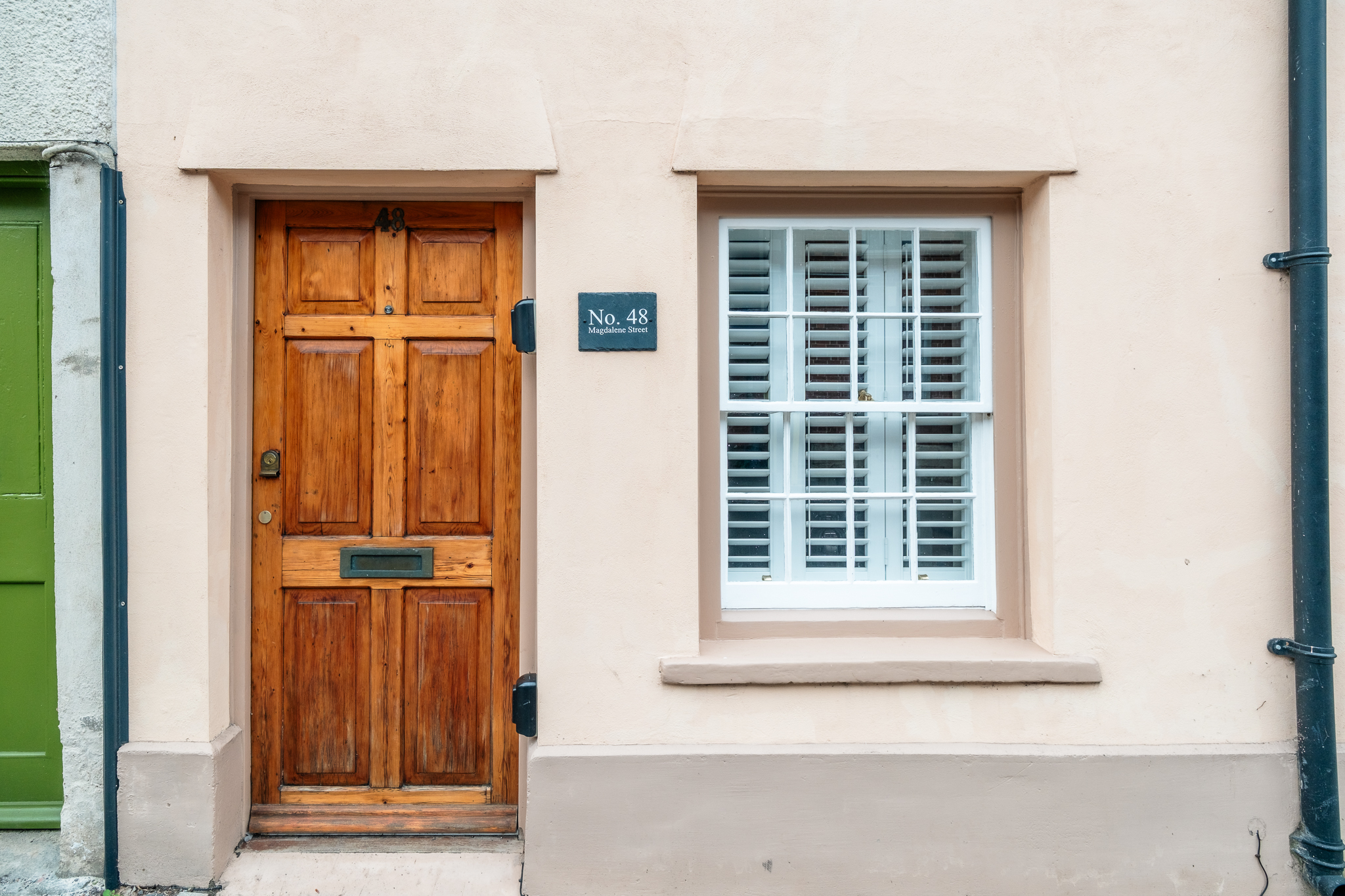 Front door of No. 48 Magdalene Street with brass house number plaque